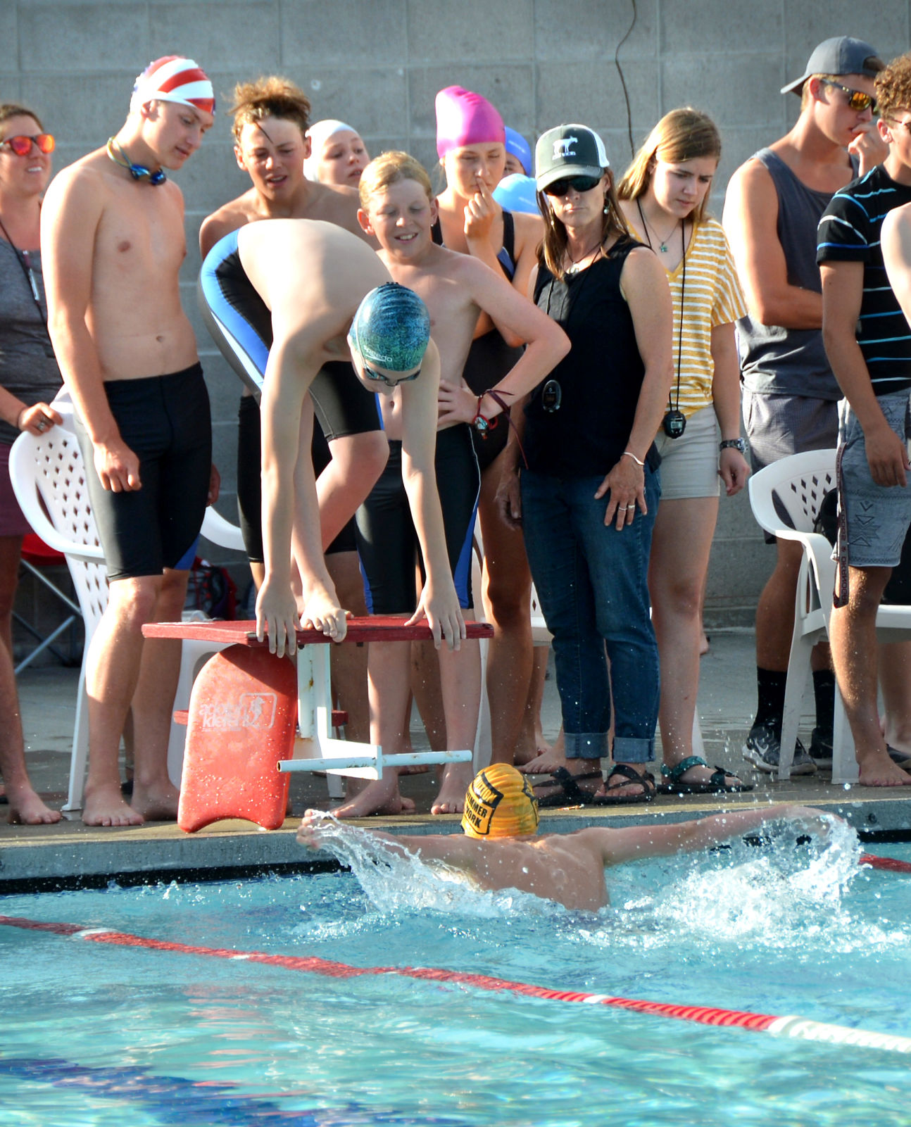 Swimmer gets ready to dive into Brewster pool during relay